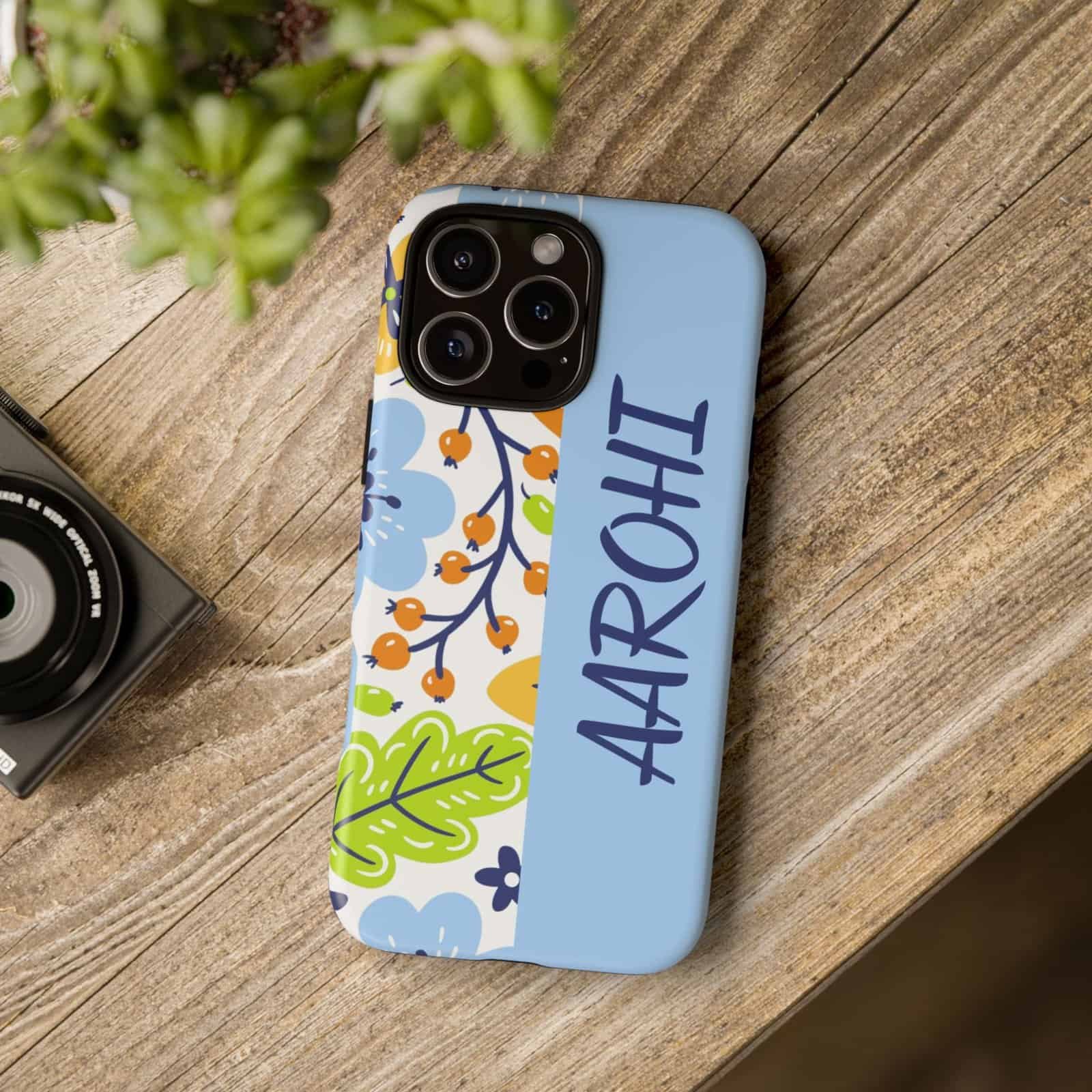 Sleek personalized iPhone case with floral and leaf design, customized with name "Aarohi.".