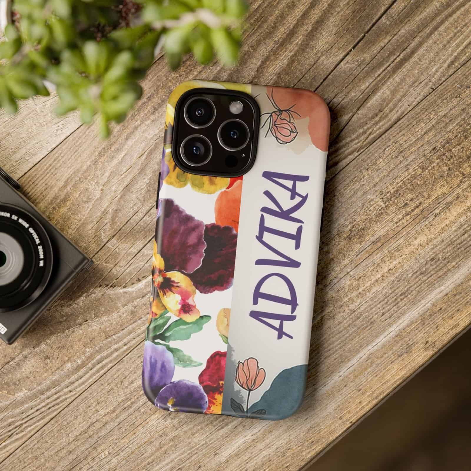 Colorful floral phone case with the name "ADYIKA" for iPhone, stylish and protective accessory.
