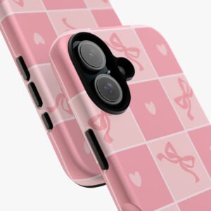 Stylish pink phone case with bow and heart designs for iPhone, provides protection and elegant appearance.