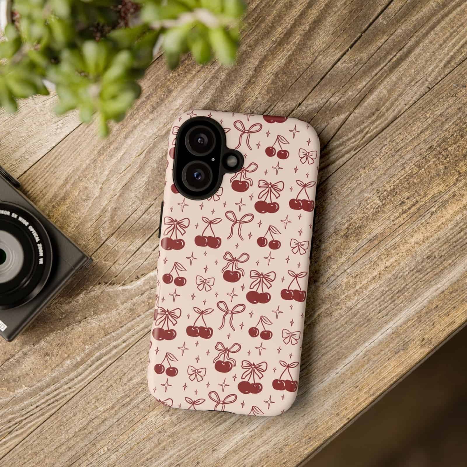 Cherry-patterned phone case for iPhone with bows and stars design.
