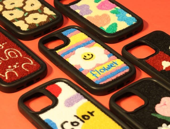 Colorful plush phone cases with happy and playful designs for smartphones, enhancing style and protection.