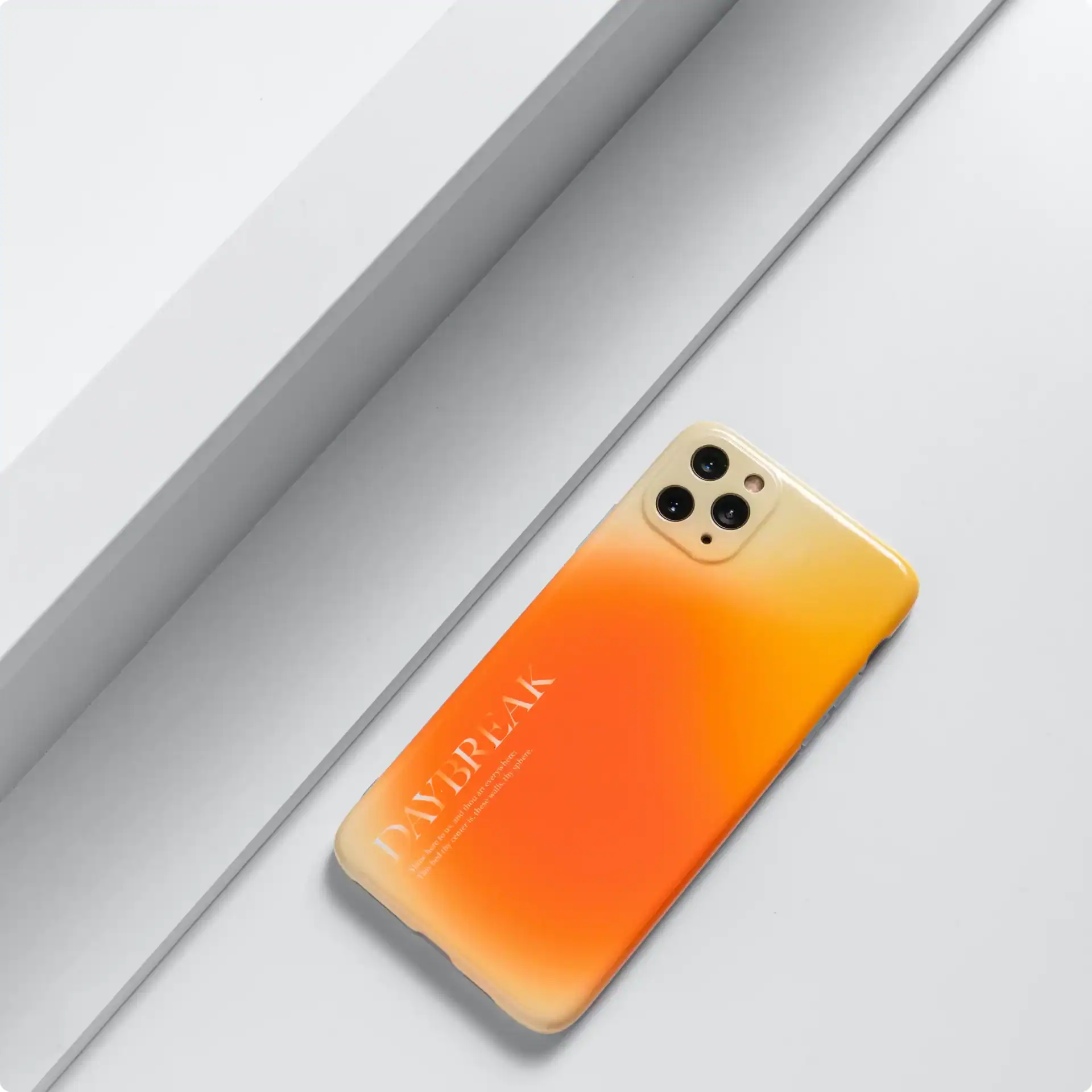 3. Bright yellow and orange gradient phone case for iPhone with stylish "DAYBREAK" text design.